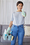 Cleaner, thumbs up and portrait of a woman with supplies to clean the living room of a house. Happy, smile and female maid or housewife with a positive mindset for cleaning an apartment, loft or home