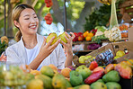 Woman, fruit and grocery shopping in outdoor market, pear choice and health product with food and nutrition in Seoul marketplace. Store, happy Asian customer and retail with sale, vegetable and smile