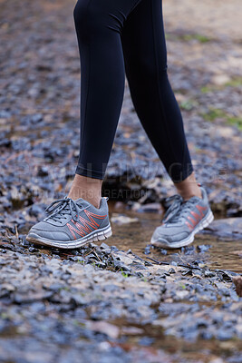 Buy stock photo Woman, running shoes and feet in mud while hiking in nature for fitness, exercise and cardio training outdoor for health, travel and wellness on adventure. Legs of female athlete walking forest path