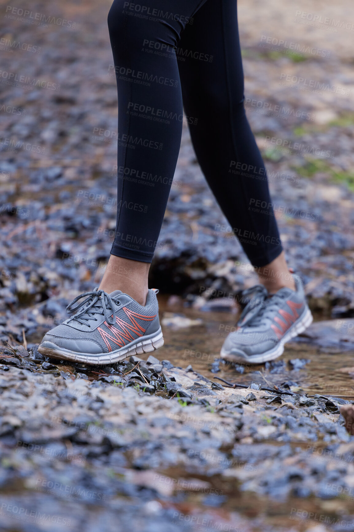Buy stock photo Woman, running shoes and feet in mud while hiking in nature for fitness, exercise and cardio training outdoor for health, travel and wellness on adventure. Legs of female athlete walking forest path