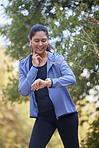 Fitness, runner and woman watch run time and heart rate in nature park doing sports and workout. Exercise, wellness and running training of an athlete checking digital smartwatch for performance 