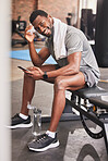 Fitness, phone and portrait of a man at gym for training, exercise and cardio while texting or checking wellness app progress. Face, black man and social media health influencer post workout for blog