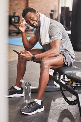 Buy stock photo Fitness, phone and portrait of a man at gym for training, exercise and cardio while texting or checking wellness app progress. Face, black man and social media health influencer post workout for blog