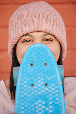 Buy stock photo Skateboard, young face and woman hiding with winter beanie, clothes and gen z fashion, hipster culture and happiness in city. Portrait, happy and shy skater girl, eyes and relax for fun at skate park