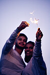 Couple, sparklers and happy together for night celebration or romance date for love, support and freedom outdoor. Smile, Indian woman and man hugging or quality time to celebrate happiness in Bali