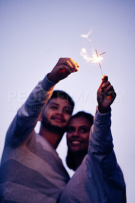Buy stock photo Couple, sparklers and happy together for night celebration or romance date for love, support and freedom outdoor. Smile, Indian woman and man hugging or quality time to celebrate happiness in Bali