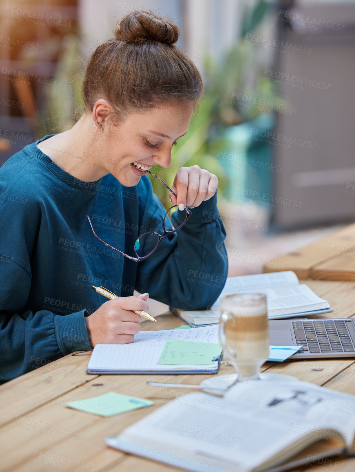Buy stock photo Woman, laptop and notebook writing in cafe, coffee shop or restaurant for university, college or school study. Smile, happy or elearning student with education technology in remote research homework