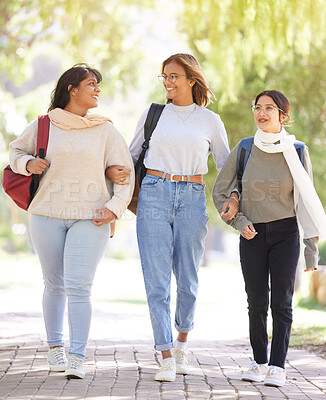 Buy stock photo Friends, women and students outdoor, walking and conversation on break, relax and smile. Young females, girls and in nature for peace, bonding together and stroll on pathway, casual and trendy look.