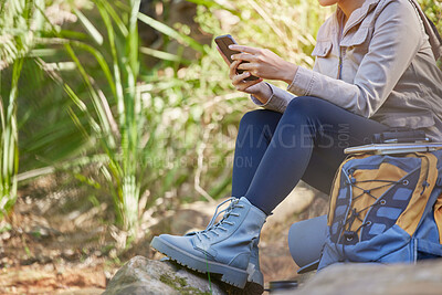 Buy stock photo Communication, phone and legs of woman in nature to relax, search gps location and trekking during travel in Nepal. 5g connection, chat and girl on a mobile app for internet while hiking in a forest
