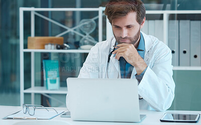 Buy stock photo Doctor, scientist and laptop with a man reading and thinking while doing medical research on database or data analysis at desk. Healthcare worker with technology for internet. search and innovation