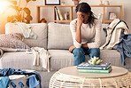 Black woman, stress and headache in depression on sofa from dirty living room or goblin mode at home. Stressed African American female tired, frustrated or suffering in mental health burnout on couch