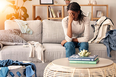 Buy stock photo Black woman, stress and headache in depression on sofa from dirty living room or goblin mode at home. Stressed African American female tired, frustrated or suffering in mental health burnout on couch