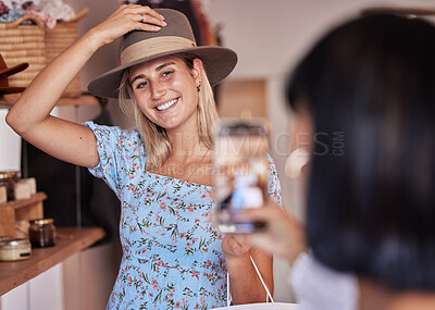 Fashion, friends shopping and taking pictures with phone for happy memory, profile picture or social media. Retail mall, sales deals and women or girls trying hats and taking mobile smartphone photo.