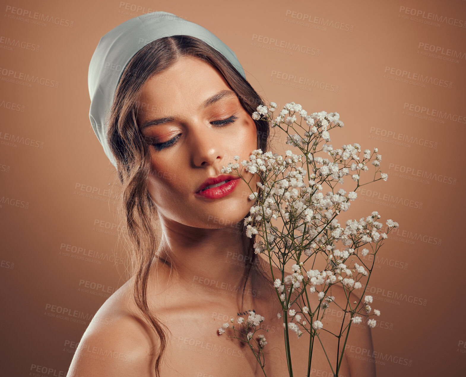 Buy stock photo Woman, face or skincare glow with flowers on brown studio background for organic dermatology, healthcare wellness or vegan facial treatment. Beauty model, scarf or plant bouquet with makeup cosmetics