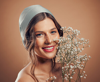 Buy stock photo Woman, face or skincare glow with flowers on studio background in Canada dermatology, organic collagen treatment or fresh self love. Portrait, smile or happy beauty model with plants or satin scarf