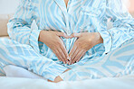 Pregnancy, woman and heart hands on pregnant stomach of a future mother ready for baby with love. Wellness, hope and hand sign to show gratitude, faith and happiness of a pregnant woman at morning