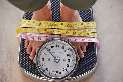 Buy stock photo Top view, feet on scale and tape to lose weight, health and diet for wellness, balance and fitness. Foot, measure and results after training, healthy lifestyle or commitment to exercise and weighing