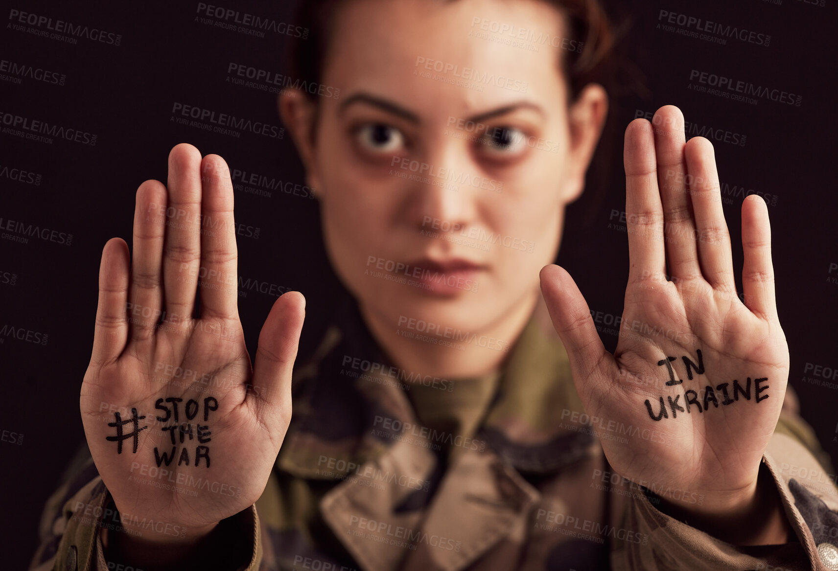 Buy stock photo Ukraine, war and stop with woman soldier showing her hands or palms in protect to military conflict. Army, freedom and politics with a female trooper in support of Ukrainian freedm or rights