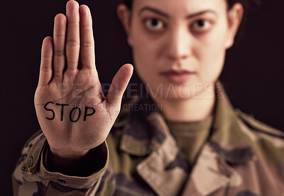 Buy stock photo Stop, war and hand of a military woman angry, frustrated and with sign against a dark black studio background. Army, anger and portrait of a soldier with body language and message to end a battle