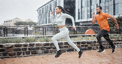 Running, fitness and couple in the rain with runner energy, speed and fast people doing sport. City, exercise and workout sports in winter doing cardio for a marathon or race athlete training