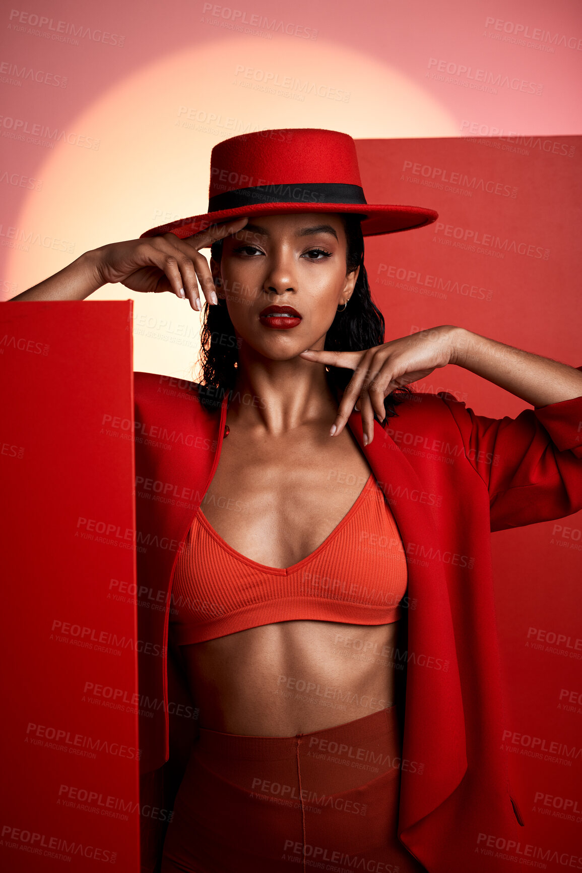 Buy stock photo Beauty, fashion and red aesthetic woman in studio for creative art portrait for makeup, cosmetics and designer brand clothes. Face of 90s edgy style London model in a suit and hat for magazine cover