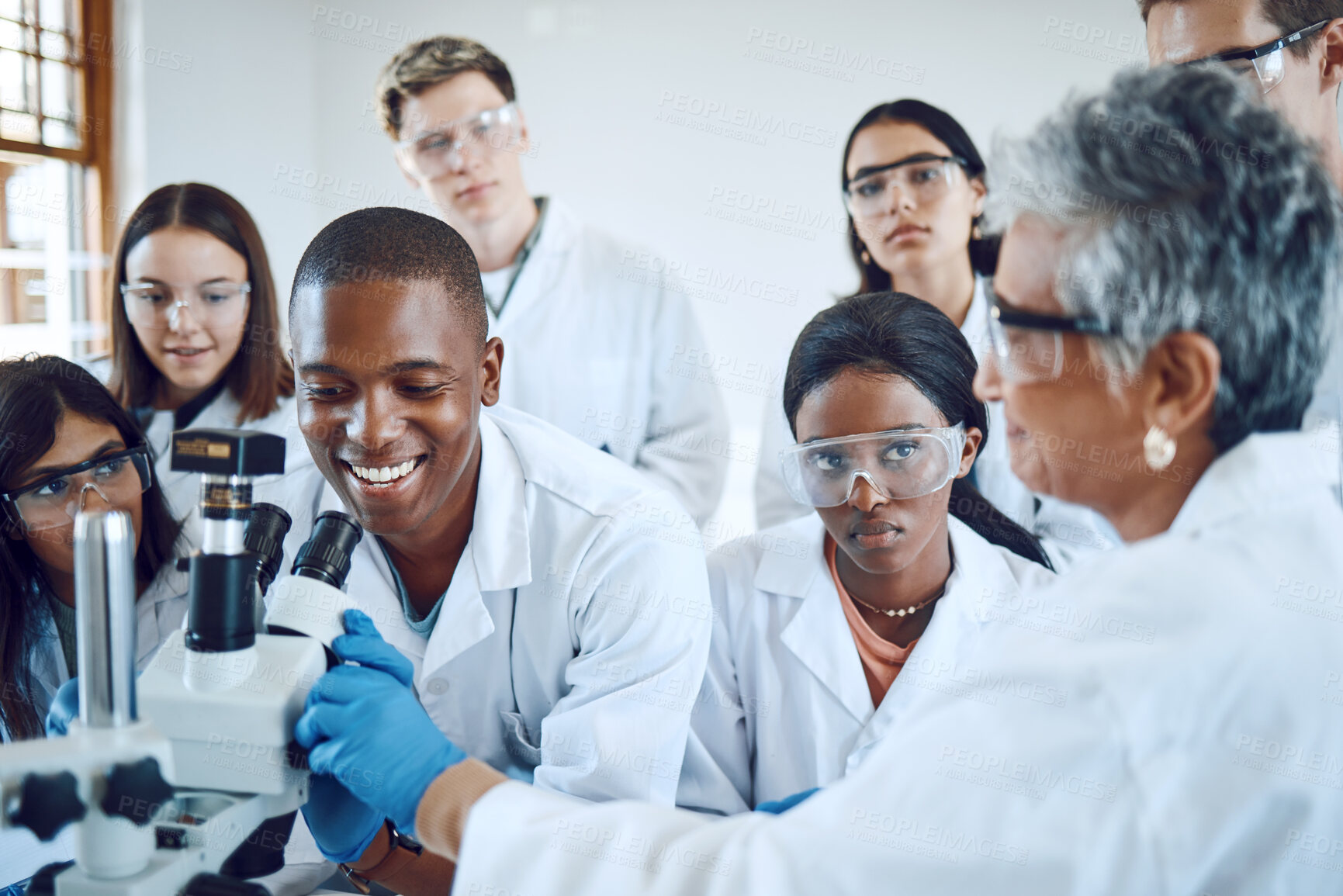 Buy stock photo Education, science and teacher with students using microscope for chemistry, biology and medical research . Medicine, healthcare lab and mentor with university class to study analytics of dna sample