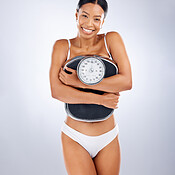 Body, legs and tape measure with a woman in studio on a gray background  measuring for weightloss. F Stock Photo by YuriArcursPeopleimages