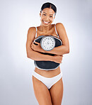 Woman, scale and weight loss portrait with underwear, health and wellness with smile by studio background. Black woman, diet and body goals for fitness, happiness and self care in by studio backdrop