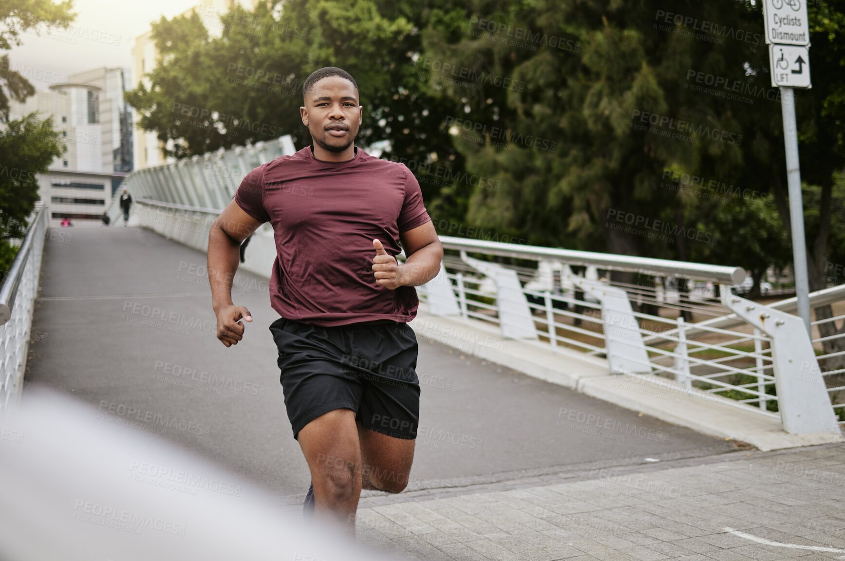 Buy stock photo Running, fitness and black man on bridge or in the city for body workout, cardio goals and marathon training with speed, energy and focus. Portrait of sports runner in usa street for a fast exercise
