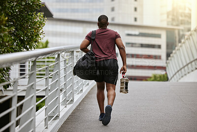 Buy stock photo Fitness, city or black man walking to gym on a bridge with a sports bag or water bottle for a workout or exercise. Back view, motivation or healthy person traveling to a training center or club