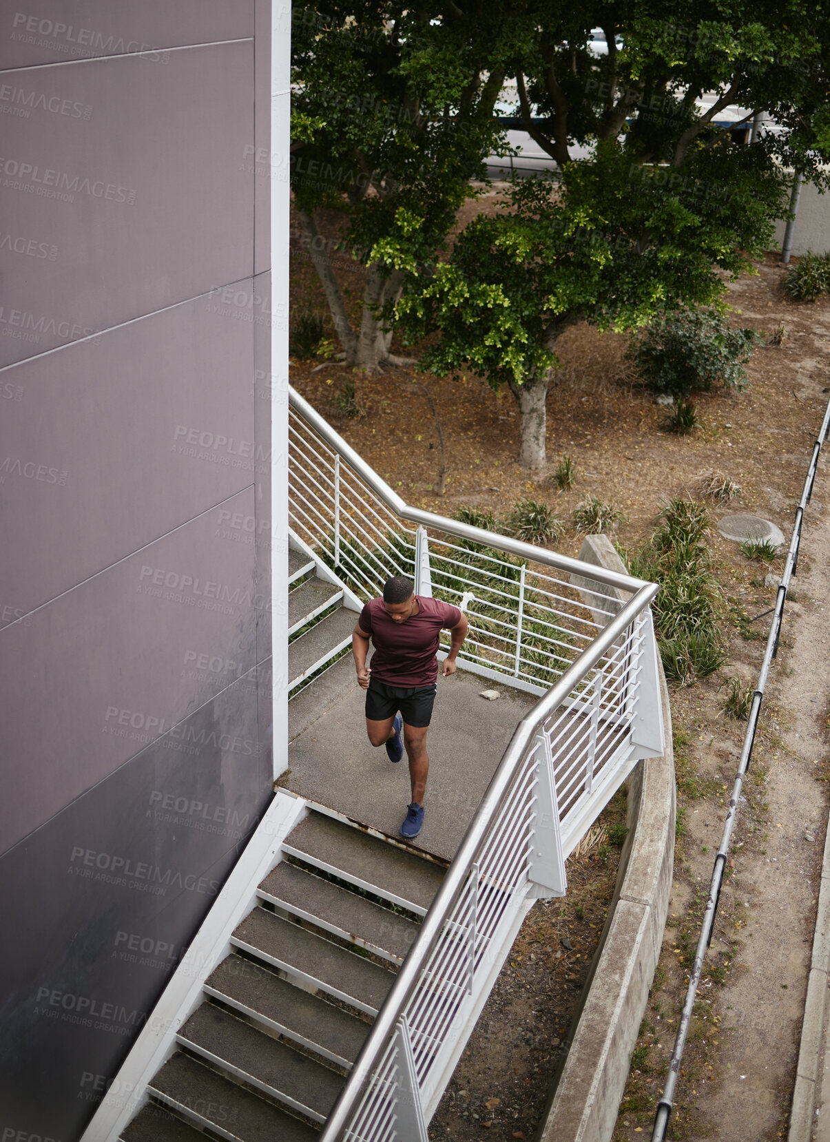 Buy stock photo Running, fitness and training with man on stairs for sports, workout and cardio endurance. Mindset, challenge and focus with runner on steps of building for speed, exercise and sports marathon