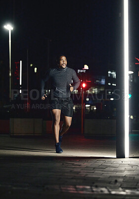 Running, fitness and man in night city for training muscle, body goals and lose weight challenge in motivation, energy and speed. Sports, athlete and cardio runner in dark urban street and spotlight