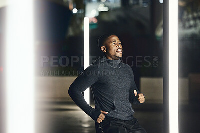 Buy stock photo African runner man, night and city for training, speed exercise or wellness on dark street with focus. Black man running, evening workout and urban metro for fitness, balance or fast run in Cape Town