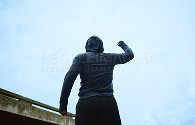 Buy stock photo Sport, success and fitness man celebrating win, achievement and victory after outdoor training against blue sky background. Happy, exercise and guy excited about body goals, performance and workout 