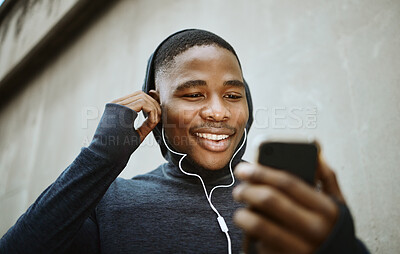Buy stock photo Music, phone and running with black man in city for streaming, podcast and mobile radio. Workout, health and cardio with face of runner with earphones by wall for training, sports and endurance 