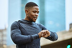 Fitness, black man and checking time in the city ready for exercise, workout or cardio training in the outdoors. Active man in sports looking at smart watch for heart monitoring, rate or performance