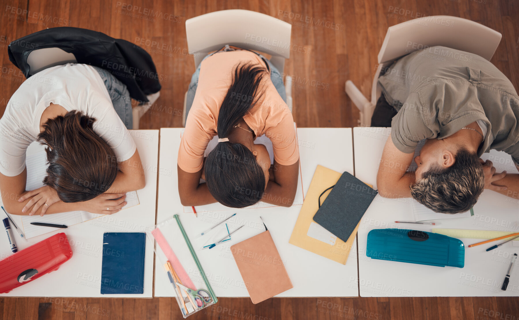 Buy stock photo Sleeping, study and desk group students with learning, education and school fatigue, depression or mental health risk. Burnout, stress and tired friends with books on table in library or school above