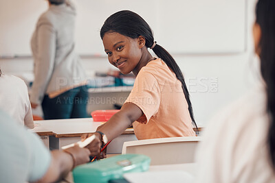 Buy stock photo Girl, teenager or passing note in classroom for secret gossip, news or prom date question on high school or college campus. Smile, happy or students with paper message in education or learning lesson