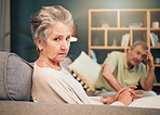 Stress, anxiety and senior couple in therapy on sofa for marriage counseling and senior care. Angry old woman, mental health care and relationship advice or support for divorce or marriage burnout.