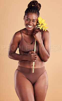 Buy stock photo Beauty, wellness and portrait of black woman with sunflower in studio for skincare, self care and self love. Health, cosmetics and plus size girl with flower for natural beauty products and makeup