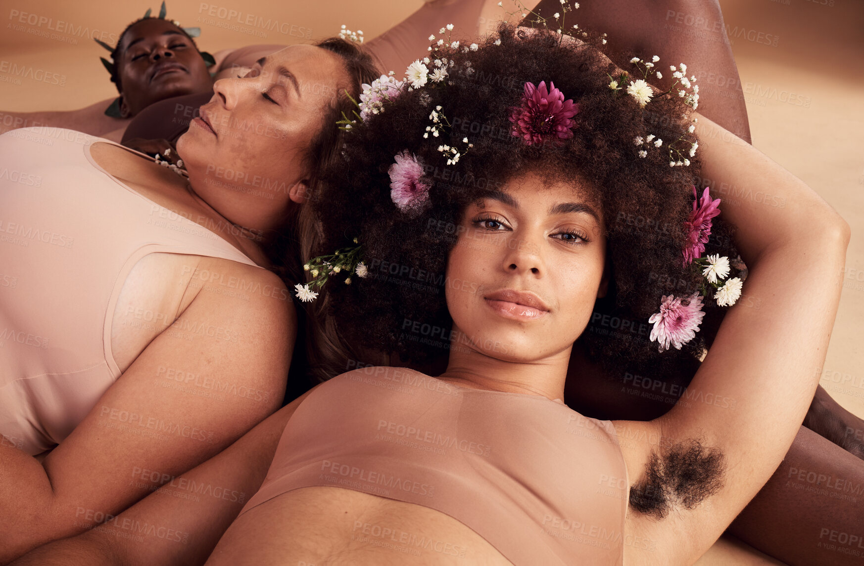 Buy stock photo Armpit hair, confidence and floral black woman with natural beauty, body health and happy in skin with a group of women in studio. Creative, flower crown and portrait of a model with hairy underarm