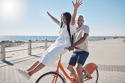 Buy stock photo Bicycle, beach and couple with freedom, travel and summer holiday in city sidewalk for wellness, love and care in sunshine. Mental health, black woman and cycling partner at ocean on blue sky mockup