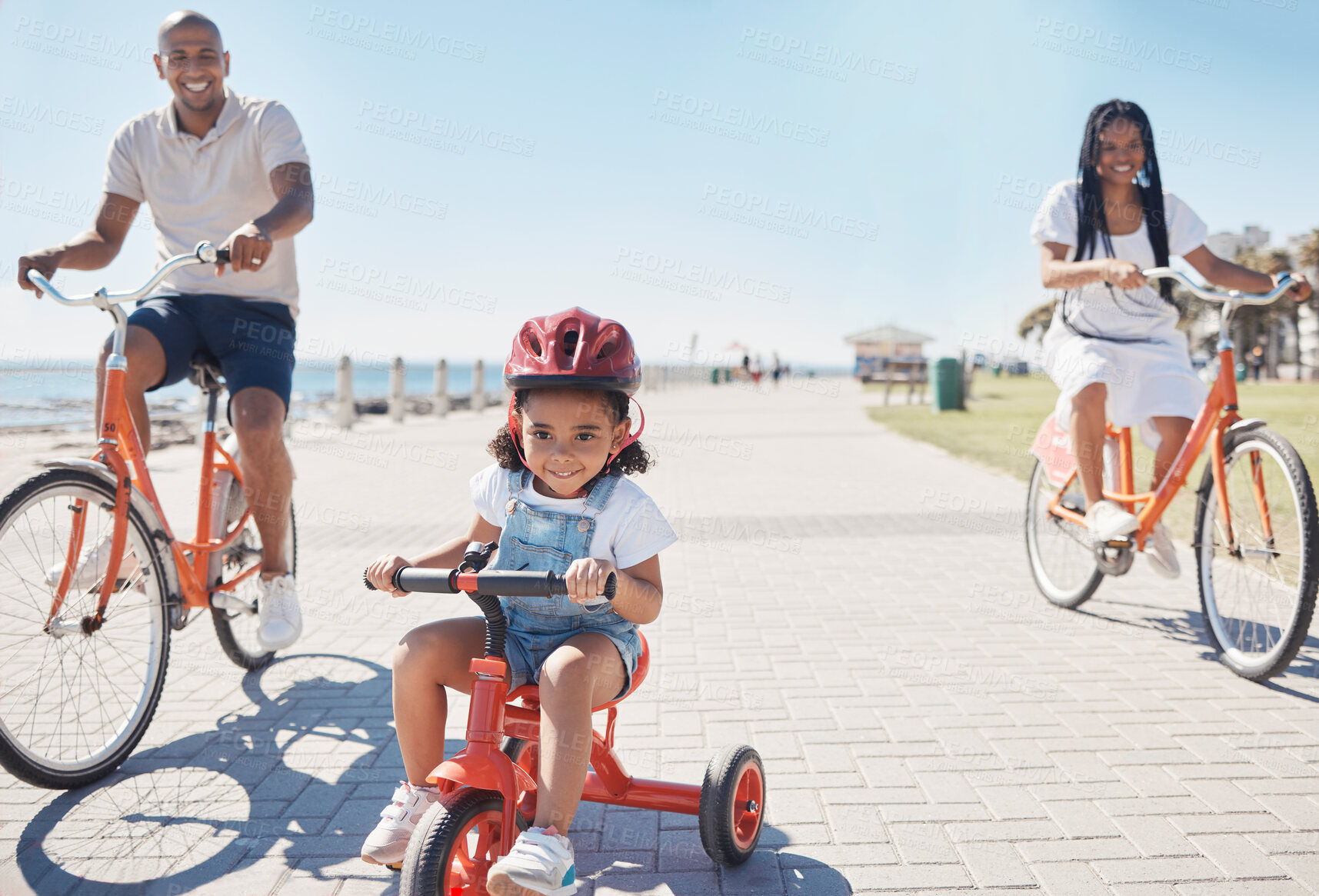 Buy stock photo Cycling, bonding and family on the promenade with a bike for summer fitness, fun and quality time in Thailand. Learning, happiness and girl child with bicycle, mother and father at a park by the sea