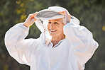 Beekeeper, safety suit and senior farm worker woman ready for honey, bee and produce production. Happy, agriculture and elderly sustainability worker in garden or field with a smile with safety 