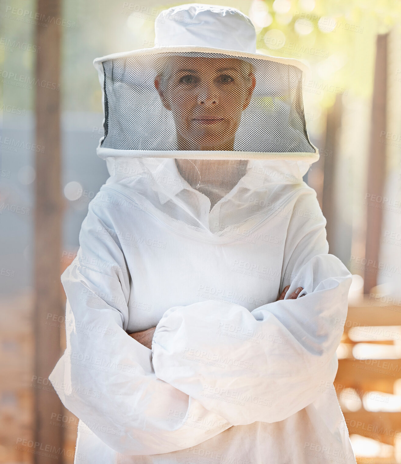 Buy stock photo Portrait, beekeeper and woman with arms crossed at farm getting ready for work. Leadership, beekeeping and female small business farmer and mature worker preparing for honey harvest in safety suit.