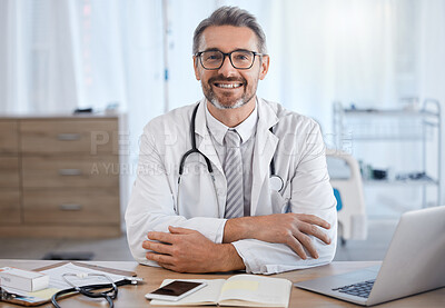 Buy stock photo Healthcare, hospital and portrait of doctor at desk for trust, medical support and ready for consultation. Wellness, medicine and senior health care worker with laptop, book and insurance paperwork