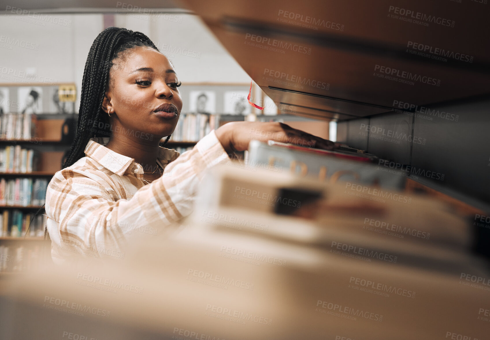Buy stock photo Black woman, library shelf and books for reading, student knowledge or education development at university. African woman, young college girl and learning, study or university research at bookstore