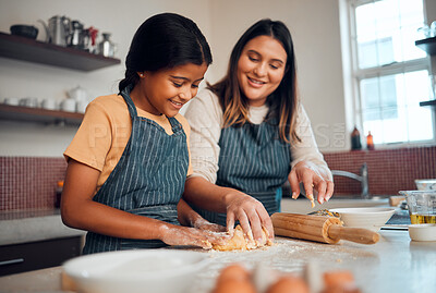 Buy stock photo Baking, family and love with a daughter and mother teaching a girl about cooking baked goods in a kitchen. Food, children and learning with an indian woman and girl together in their home to bake