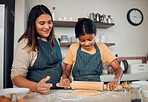 Family, baking and home kitchen with a mother teaching daughter to bake cookies with rolling pin for dough on counter. Woman and girl child together for cooking food education and development at home