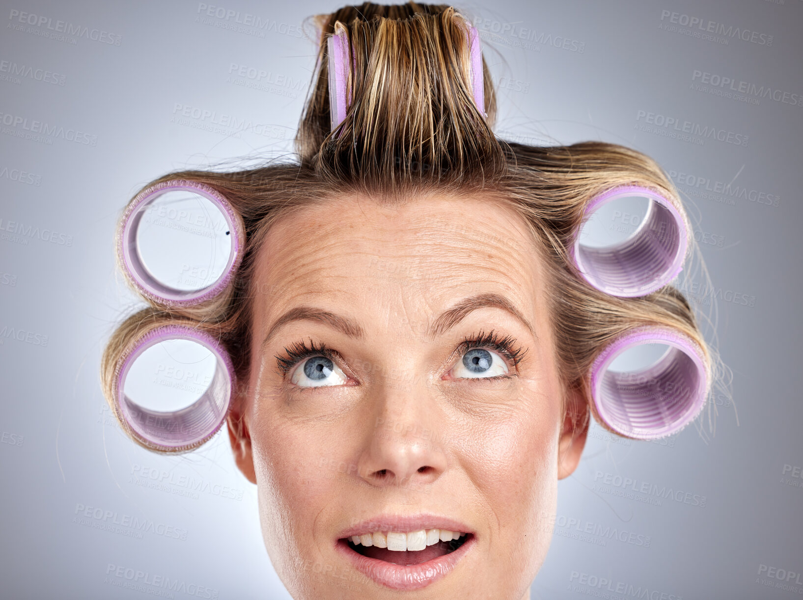Buy stock photo Hair, rollers and beauty with a model woman in studio on a gray background for a hairstyle using curlers. Hair care, thinking and face with an attractive young female styling her curly extensions